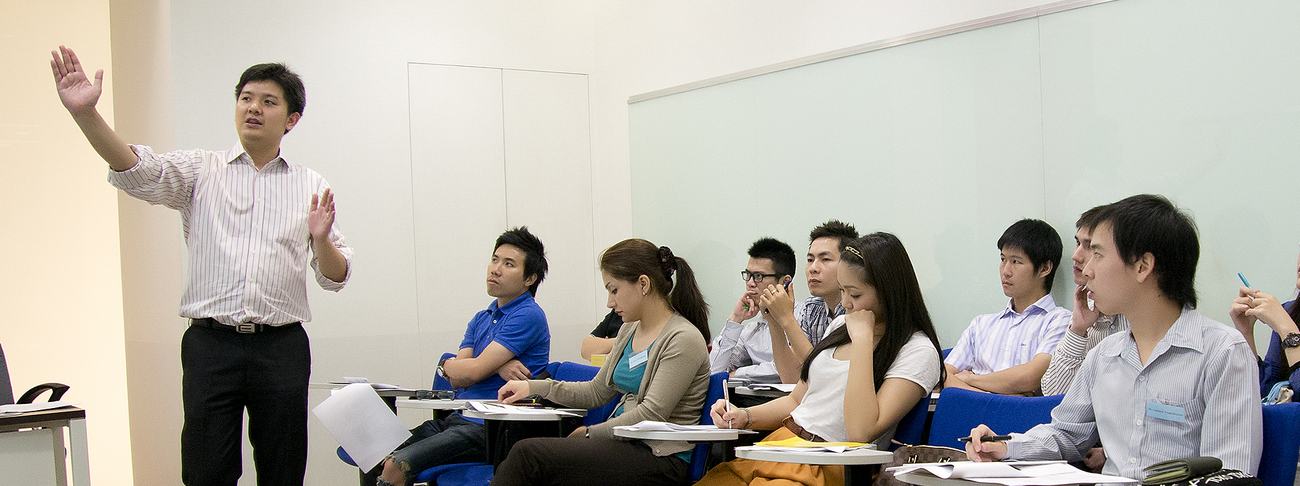 A lecturer teaching a graduate class in English
